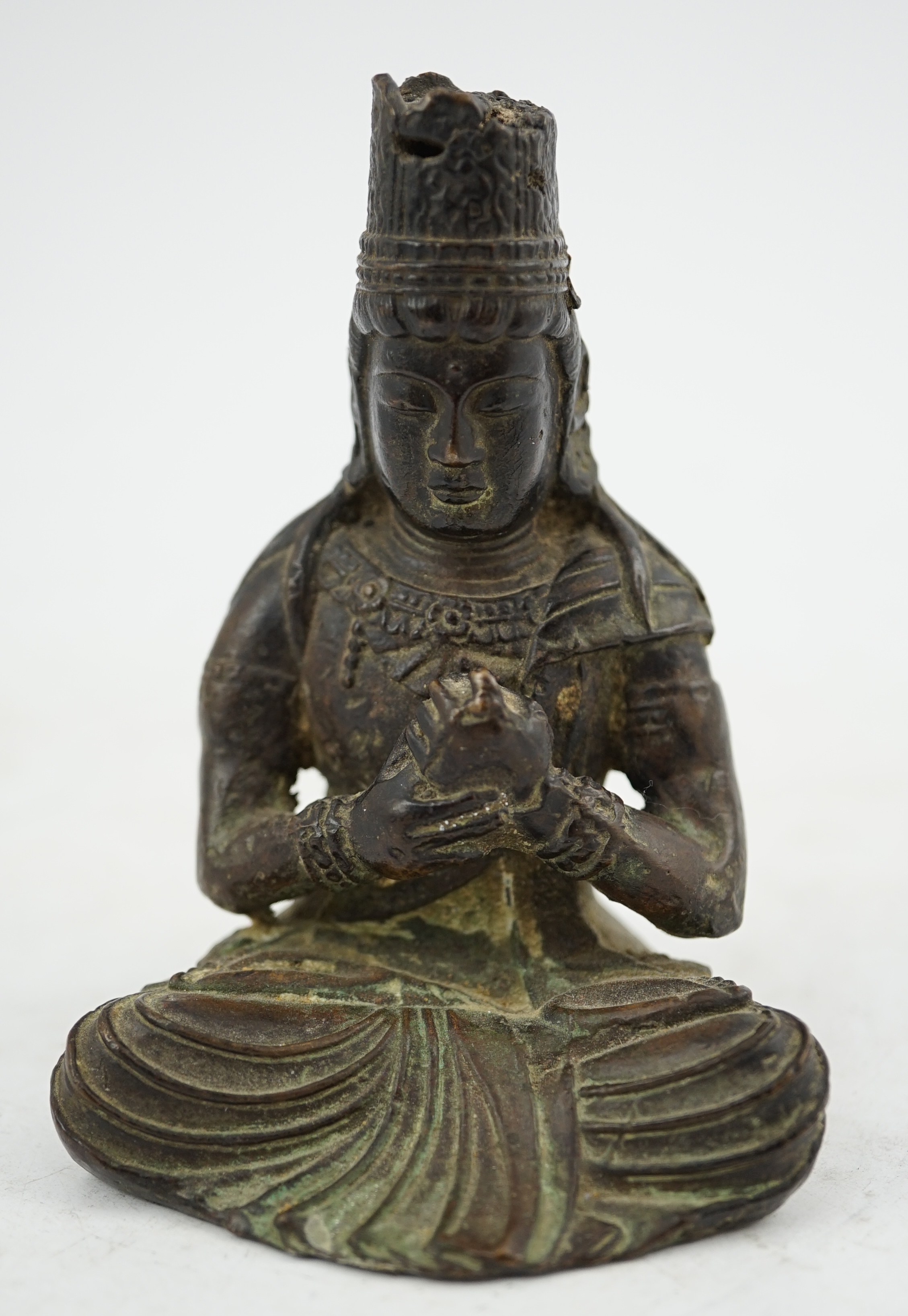 A small South East Asian bronze seated figure of Vairocana Buddha, probably 17th/18th century